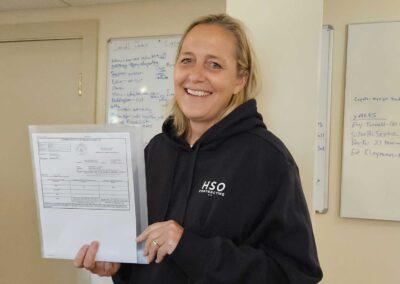woman holding a building permit in the offices of HSO contracting